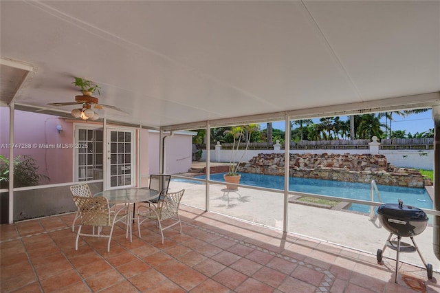 exterior space featuring ceiling fan, french doors, a fenced in pool, and grilling area