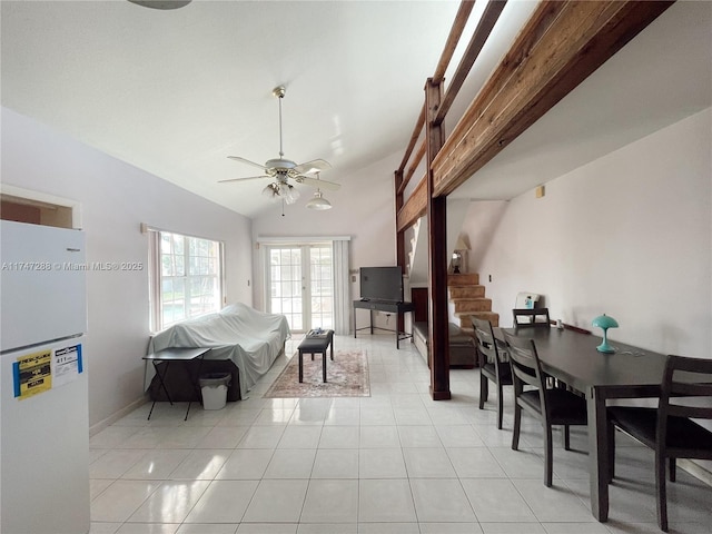 tiled living room featuring ceiling fan and lofted ceiling