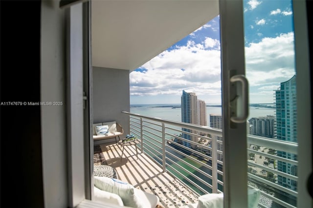 balcony featuring a water view and a view of city