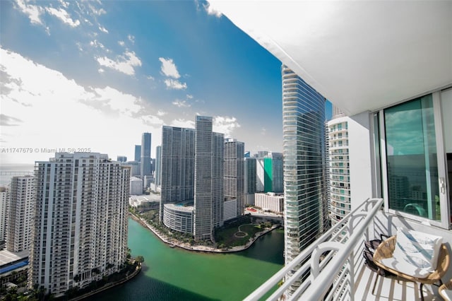 balcony featuring a view of city and a water view