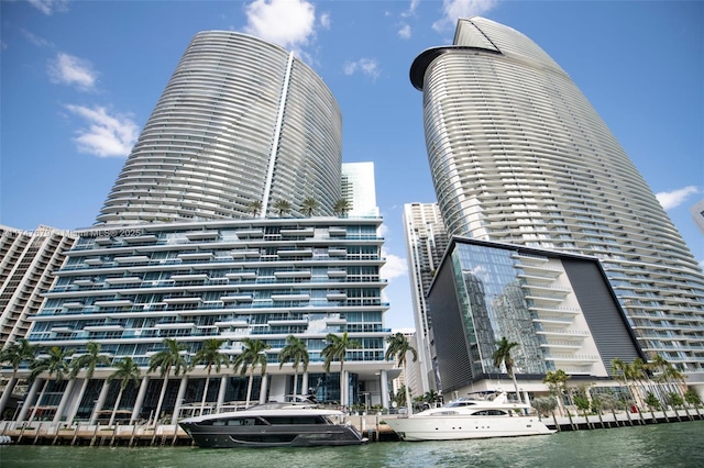 view of building exterior featuring a water view and a city view