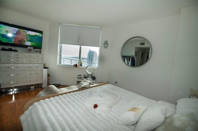 bedroom with dark wood-style flooring and visible vents