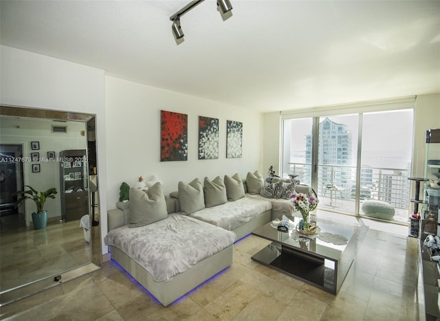 living area featuring a view of city, visible vents, and floor to ceiling windows