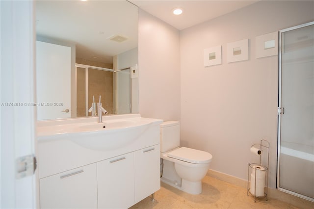 bathroom with vanity, tile patterned floors, toilet, and a shower stall