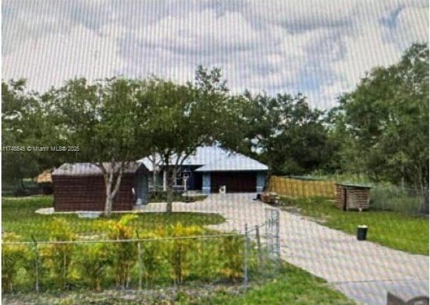 view of community featuring fence and a yard