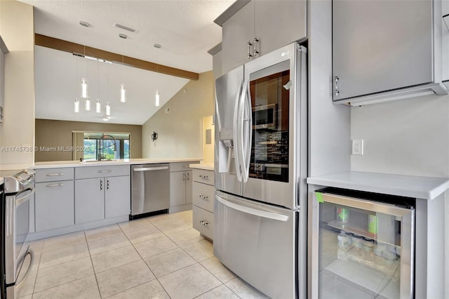 kitchen featuring appliances with stainless steel finishes, vaulted ceiling with beams, decorative light fixtures, beverage cooler, and gray cabinets