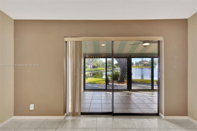 interior space with a water view and light tile patterned floors