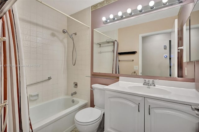 full bathroom featuring toilet, vanity, and tiled shower / bath