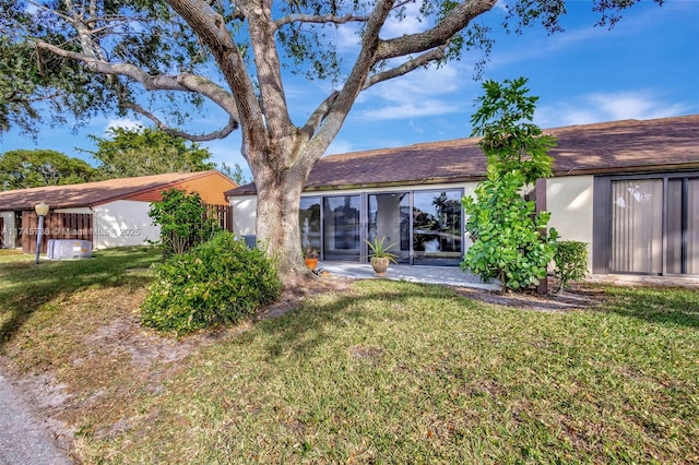 rear view of property with a yard