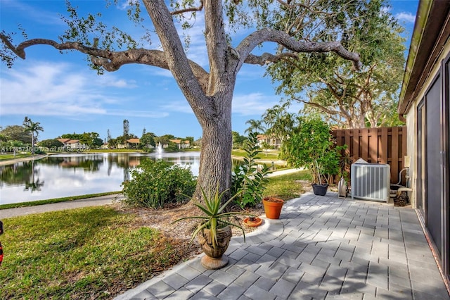 view of patio / terrace with a water view and central AC unit