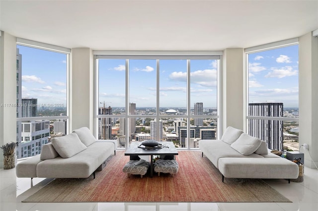 living room featuring plenty of natural light, tile patterned floors, and a wall of windows