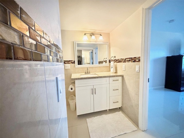 bathroom featuring tile patterned floors, tile walls, and vanity