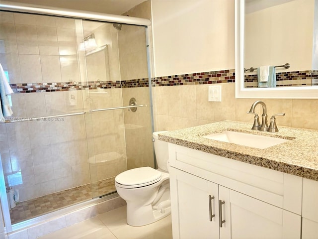 bathroom with toilet, tile walls, an enclosed shower, tile patterned floors, and vanity