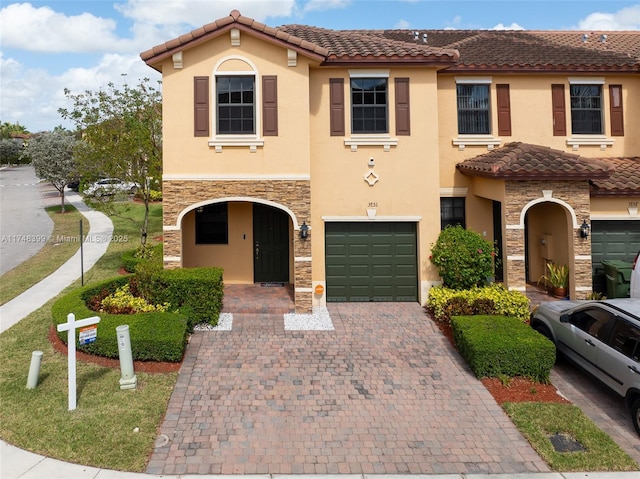 mediterranean / spanish-style home with a garage