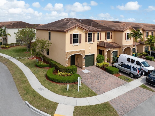 mediterranean / spanish house with a front yard and a garage