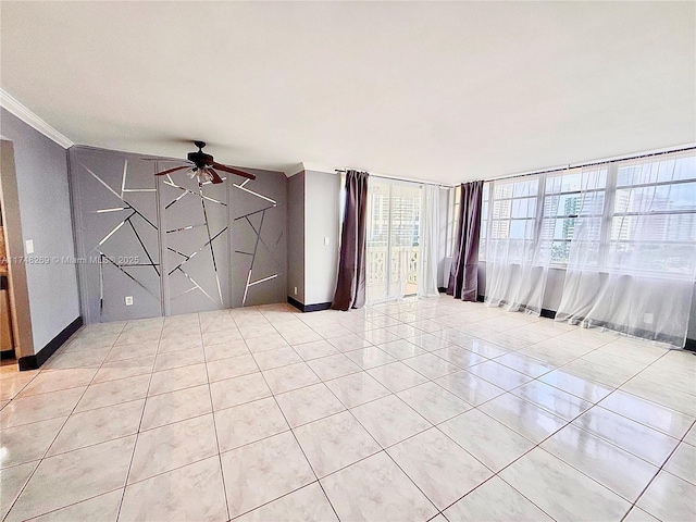 spare room featuring light tile patterned flooring, crown molding, baseboards, and ceiling fan