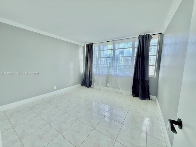 empty room featuring baseboards, light tile patterned flooring, and crown molding