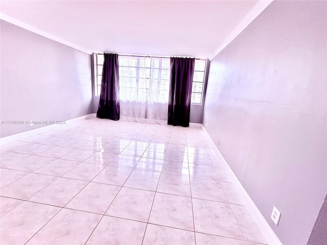 unfurnished room with baseboards, light tile patterned floors, and crown molding