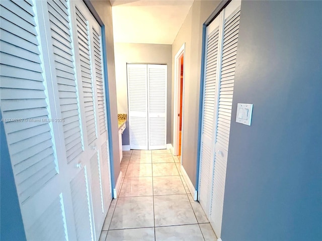 corridor featuring light tile patterned floors