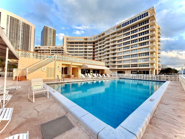 pool featuring a view of city and a patio