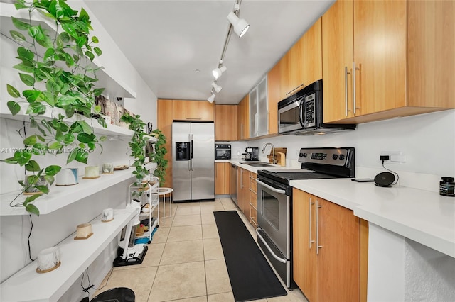 kitchen with open shelves, stainless steel appliances, light tile patterned floors, light countertops, and a sink