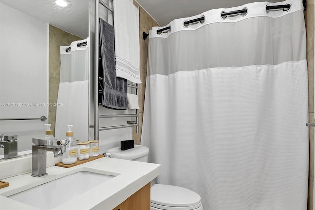 bathroom featuring toilet and vanity