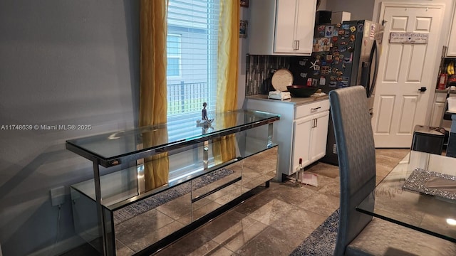 kitchen featuring white cabinetry and backsplash