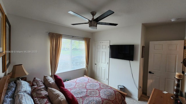 carpeted bedroom with ceiling fan