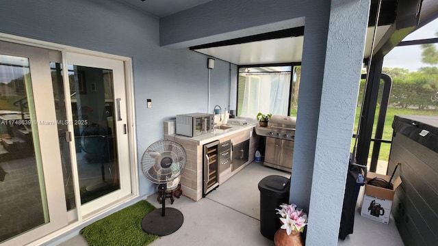 view of patio / terrace with sink, an outdoor kitchen, and wine cooler