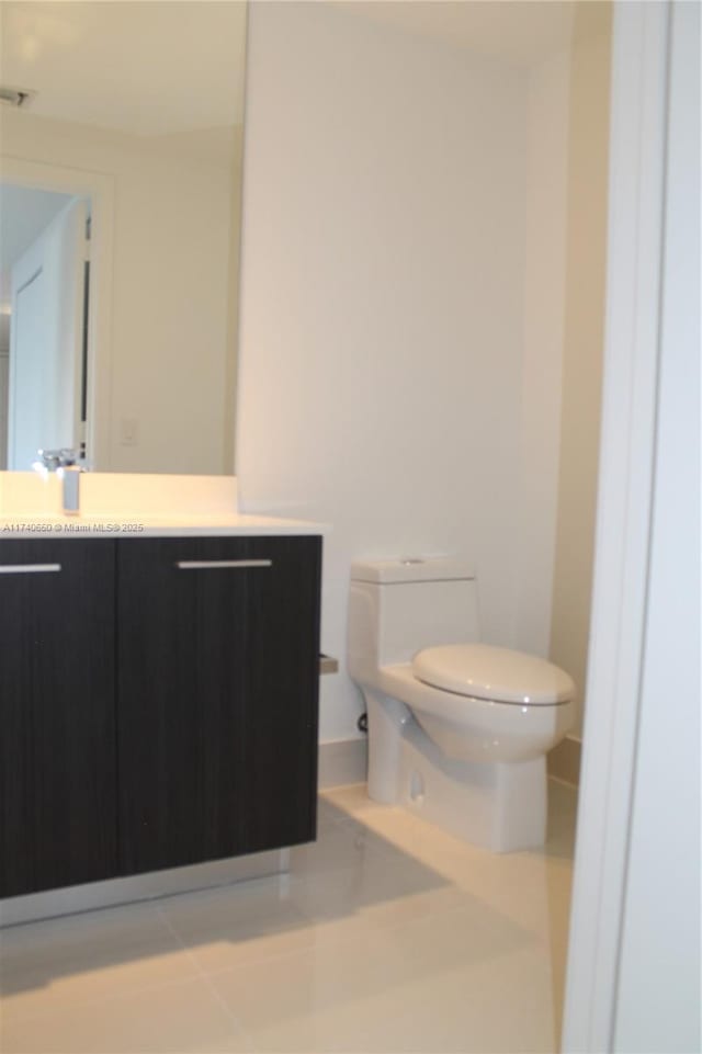 bathroom featuring visible vents, vanity, and toilet