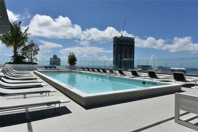 community pool featuring a view of city and a patio