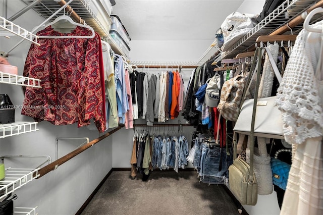 spacious closet featuring dark colored carpet