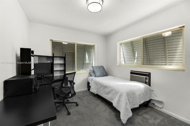 bedroom with an AC wall unit and carpet flooring