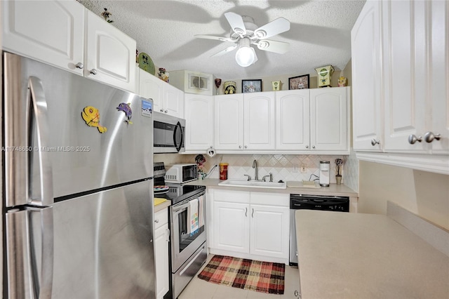 235 Kent N Unit 235, West Palm Beach, FL 33417 - kitchen featuring visible vents, light countertops, white cabinetry, a sink, and stainless steel appliances