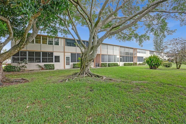 235 Kent N Unit 235, West Palm Beach, FL 33417 - back of property featuring a yard