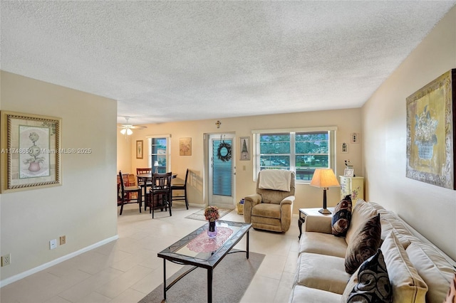 235 Kent N Unit 235, West Palm Beach, FL 33417 - living room with baseboards, a ceiling fan, a textured ceiling, and light tile patterned flooring