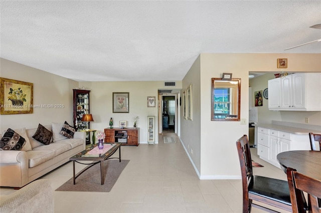 235 Kent N Unit 235, West Palm Beach, FL 33417 - living room featuring baseboards, a textured ceiling, and visible vents