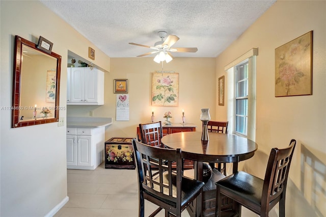 235 Kent N Unit 235, West Palm Beach, FL 33417 - dining room featuring a textured ceiling, ceiling fan, light tile patterned flooring, and baseboards