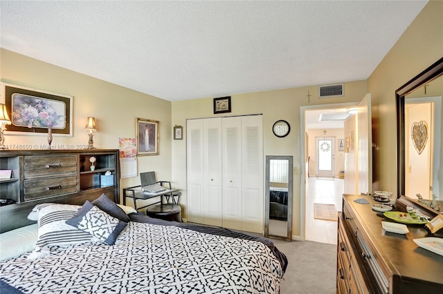 235 Kent N Unit 235, West Palm Beach, FL 33417 - carpeted bedroom with visible vents, a textured ceiling, and a closet