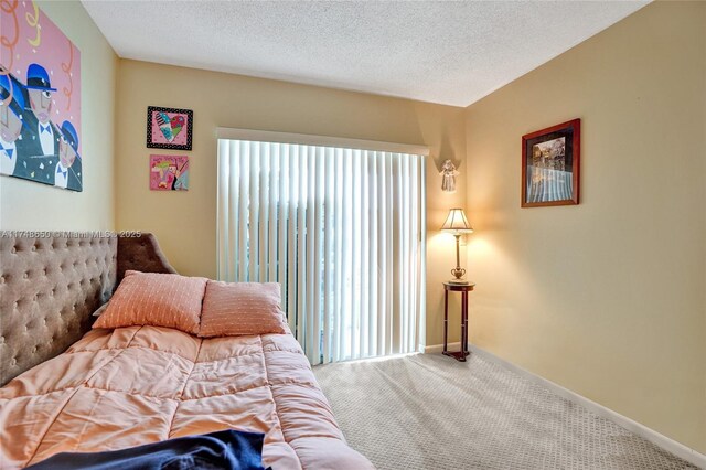235 Kent N Unit 235, West Palm Beach, FL 33417 - carpeted bedroom with a textured ceiling and baseboards