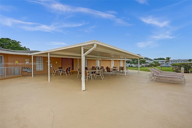 235 Kent N Unit 235, West Palm Beach, FL 33417 - back of property with outdoor dining space, stucco siding, and a patio