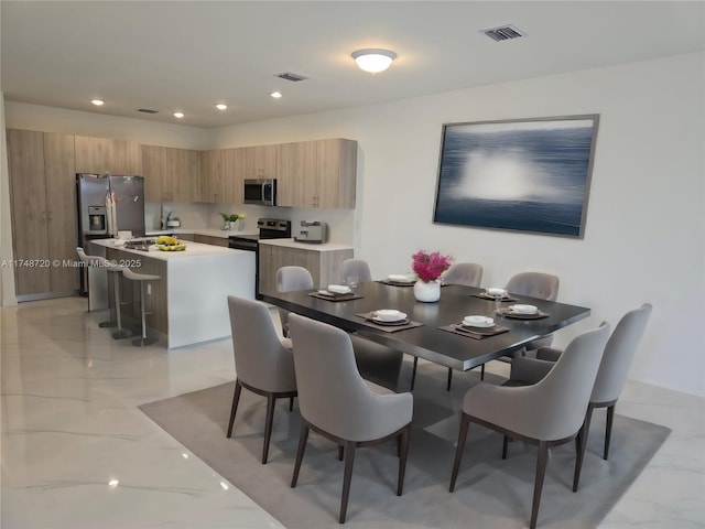 dining space featuring marble finish floor, visible vents, and recessed lighting