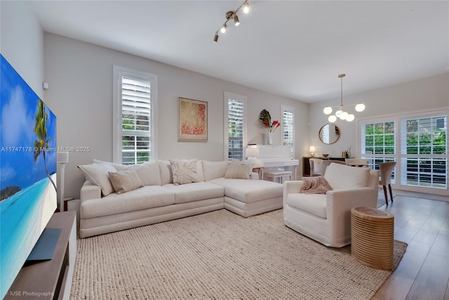 living room featuring light wood-style flooring and a chandelier