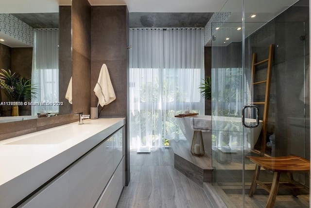 bathroom with a stall shower and vanity