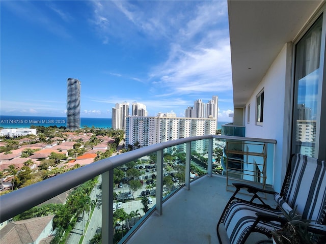 balcony with a water view and a city view