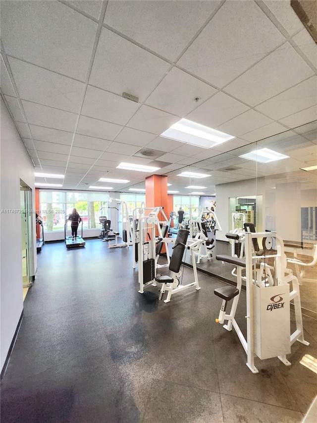 workout area with a drop ceiling and visible vents