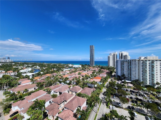 birds eye view of property with a view of city and a water view