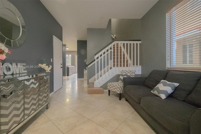 living room with light tile patterned floors and stairs