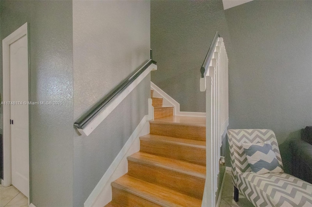 stairway with tile patterned flooring