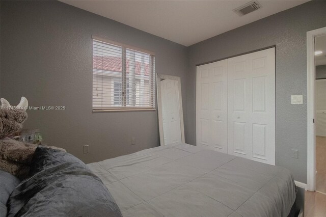 21119 NW 14th Pl Unit 437, Miami Gardens, FL 33169 - bedroom featuring a closet and a textured wall